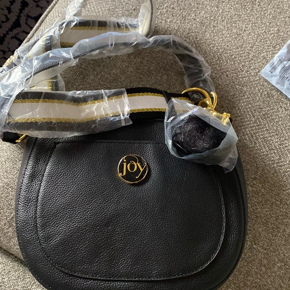 Joy crescent shaped handbag with a striped & solid black strap feather accessory